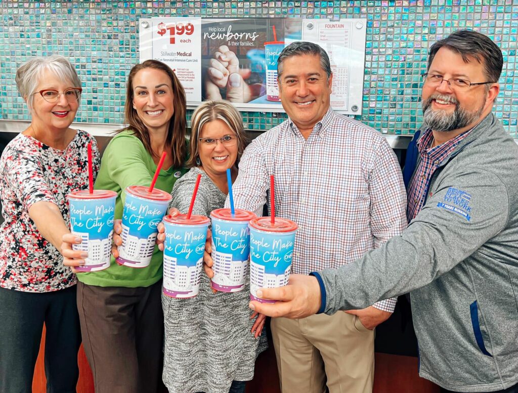 Stillwater Medical Foundation team members cheers OnCue specialty fundraiser cups at OnCue #8 in Stillwater, OK.