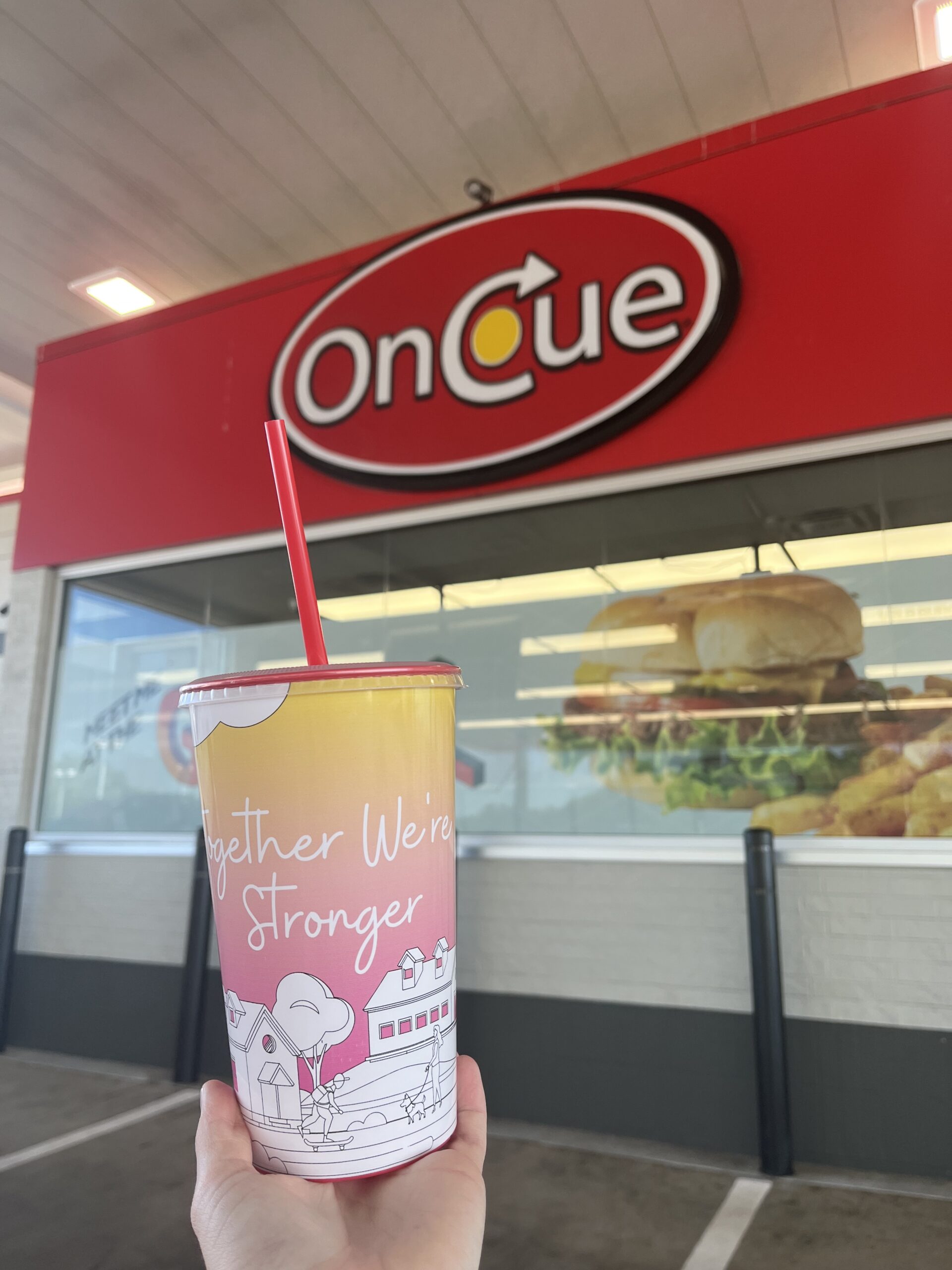 Fundraiser cup in front of OnCue store